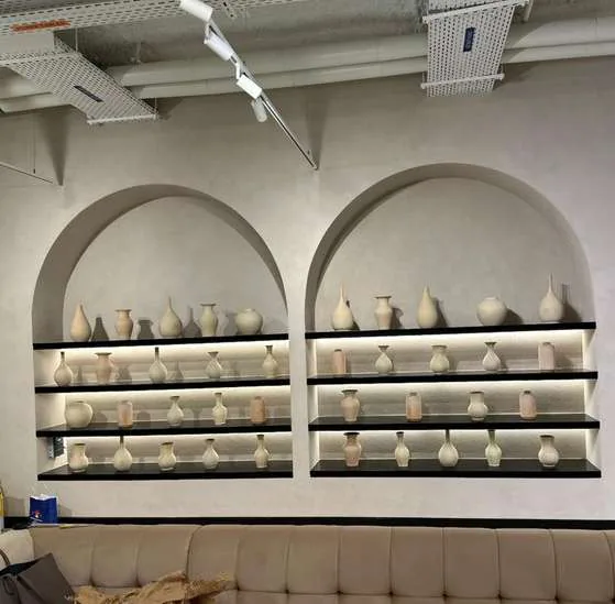 Arched shelving with curated pottery at the Dubai Media Council offices
